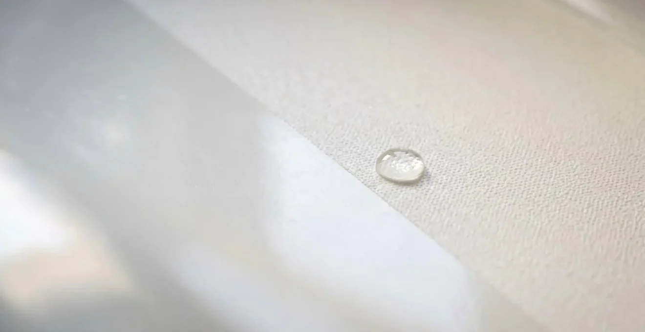 Extreme macro photograph showing the textured micro-profile of professionally applied anti-slip coating on white bathtub surface