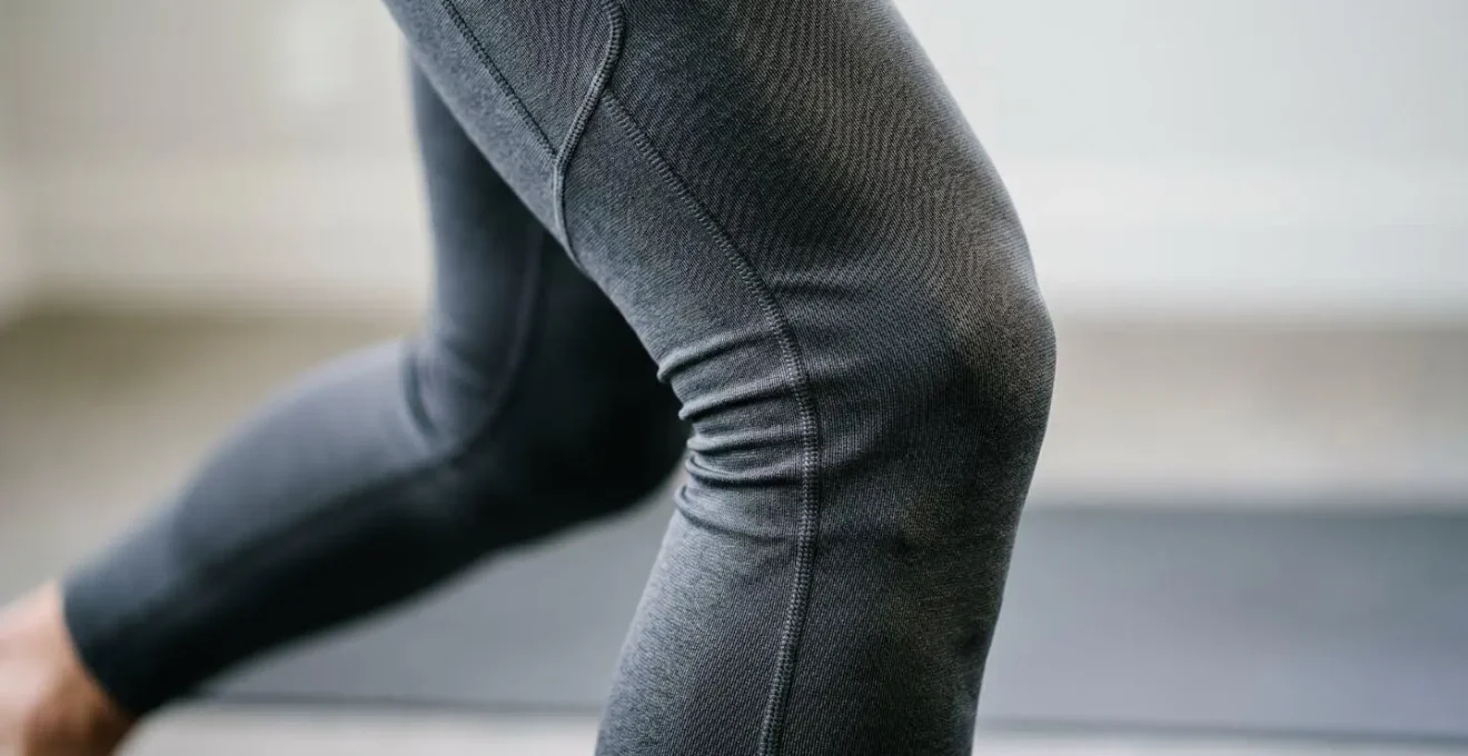 Anatomical visualization showing reduced knee joint flexion when standing from a higher toilet compared to a standard one.