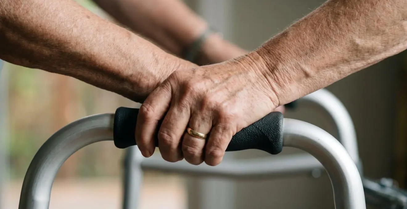 Macro close-up detail of proper hand grip position and wrist alignment on rollator handles showing neutral posture
