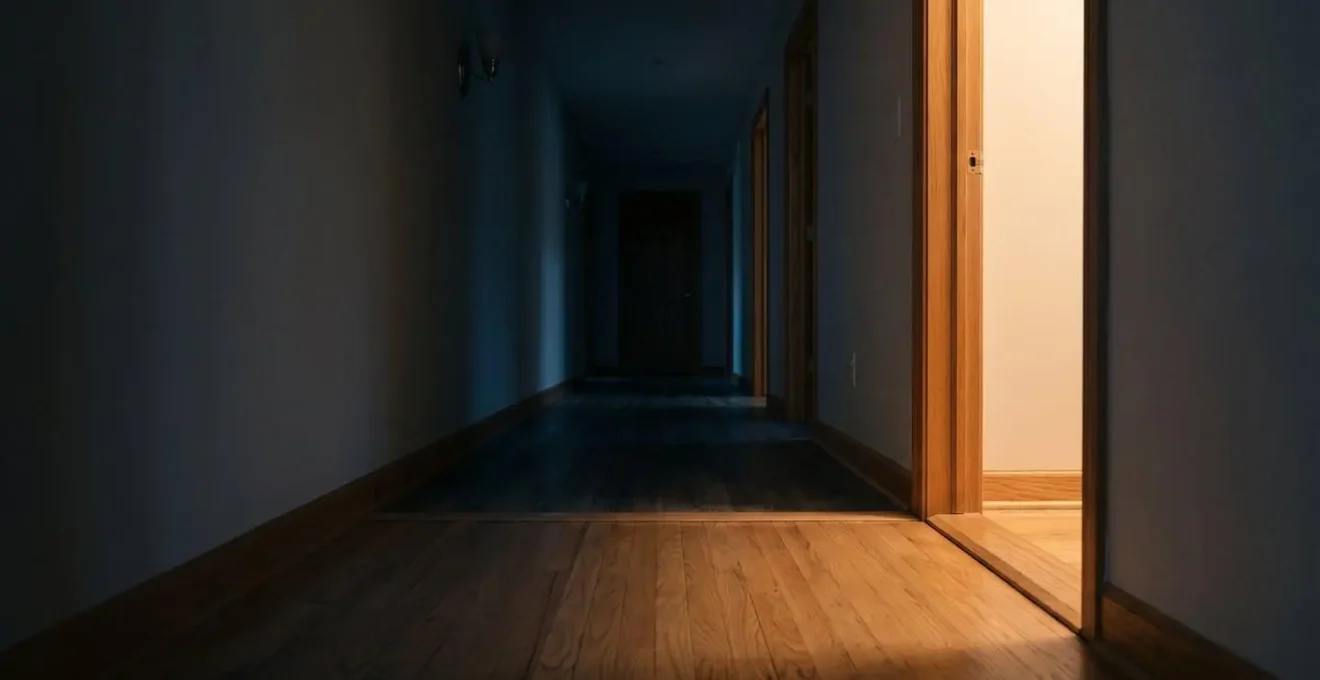 Dimly lit hallway showing contrast between light and shadow areas illustrating fall risk